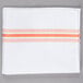 A white cloth napkin with orange stripes.