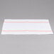 A white cloth napkin with orange stripes.