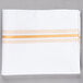 A white cloth napkin with gold stripes.