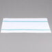 A white cloth napkin with blue stripes on a table.