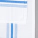 A blue and white striped Snap Drape Softweave cloth napkin.