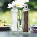 Two Tablecraft Metro glass salt and pepper shakers on a table.