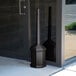 A black pole with a black metal Commercial Zone Site Saver Cigarette Receptacle.