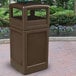 A brown rectangular Commercial Zone PolyTec waste container with an ashtray dome lid on a brick surface.