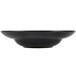 A black Hall China bowl with a white background.