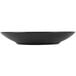 A black Hall China bowl on a table.