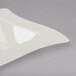 A white square Fineline disposable plastic bowl with a curved edge.