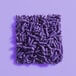 A square pile of purple sprinkles on a purple background.