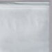 A clear plastic table cover in a white plastic bag.