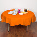 A Sunkissed Orange OctyRound table cover on a table with food.