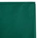 A Creative Converting hunter green plastic table cover in packaging with a zipper.