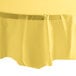 A yellow OctyRound plastic table cover on a white table.