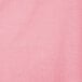 A white table cover with a textured pink pattern.