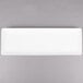 A rectangular white Libbey porcelain tray on a gray surface.