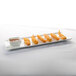 A Libbey ultra bright white rectangular porcelain tray with fried shrimp and dipping sauce.