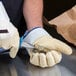 Cordova Ruffian gloves being used to shuck oysters.