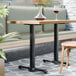 A FLAT Tech end table base with a glass of wine on it.
