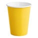 A close-up of a yellow paper cup with a white rim.