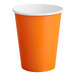 A Sunkissed Orange paper hot cup with a white rim.