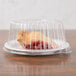 A piece of pie in a Dart clear plastic container with a clear lid.