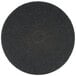 A 3M black floor stripping pad with a black center circle.