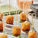 A tray of food on Tablecraft heart-shaped bamboo picks.