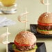 A burger with a Tablecraft bamboo pick in it.