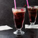 Two Anchor Hocking soda glasses with ice and brown liquid.