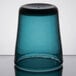 A teal Carlisle Tritan plastic glass with a black rim.