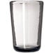 A clear Carlisle Tritan plastic juice glass with a smoke bottom and black rim.