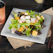 A Carlisle Grove smoke melamine salad plate with salad and a cup of soda.