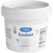A white Satin Ice container of rolled fondant with a label.