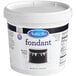 A white container of Satin Ice black rolled fondant with a black and white label.