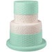 A white cake with mint green dots on top using the Wilton Fondant Embosser Set with Dot Pattern Roller.