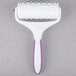 A white roller with a purple handle.