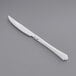 A Visions heavy weight plastic knife with a white handle on a gray surface.