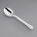 A silver spoon with a white handle.