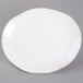 A white Tuxton china platter with a gold rim.