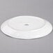 A white Tuxton china platter with a gold rim.