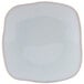 A white square Tuxton Artisan china plate with a small square design on the edge.