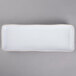 A white rectangular china tray with a thin black border.
