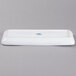 A white rectangular china tray with a blue logo.