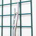 A metal bar with hooks on a grid.