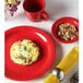 A Tuxton Cayenne Colorado fruit dish with food on it and a mug of coffee.