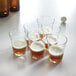 Arcoroc beer glasses filled with beer on a table.