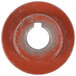 An orange round metal wheel with a hole in the middle.