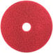 A red 3M buffing pad with a white circle in the middle.