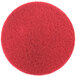 A red circular 3M floor pad.