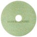 A white circular pad with a green background and a hole in the middle.