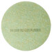 A green circular 3M TopLine Autoscrubber floor pad with text on it.